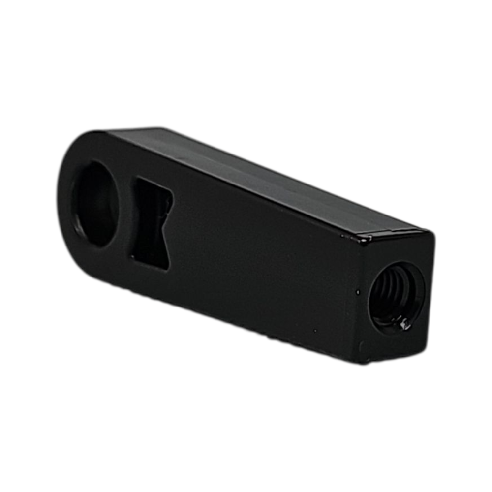 Black metal component with threaded holes on a white background